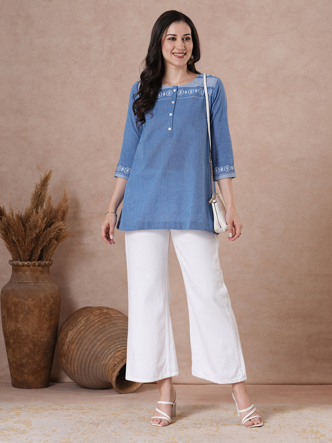 Woven cotton dobby tunic in light pink shade with hand embroidery.