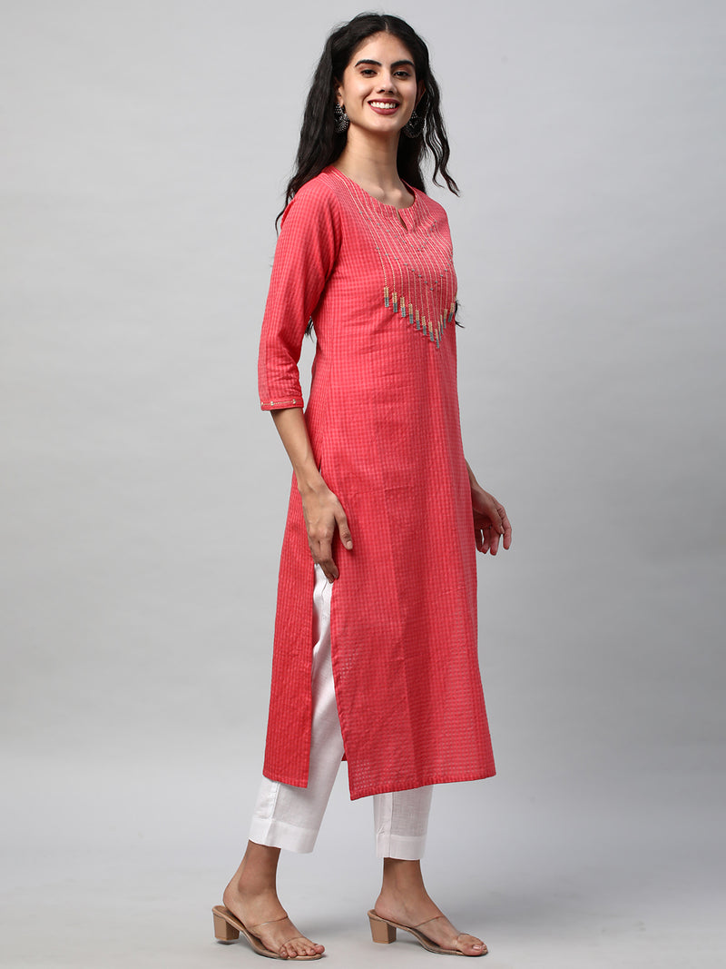 A straight kurta with machine embroidery at the center and sleeve