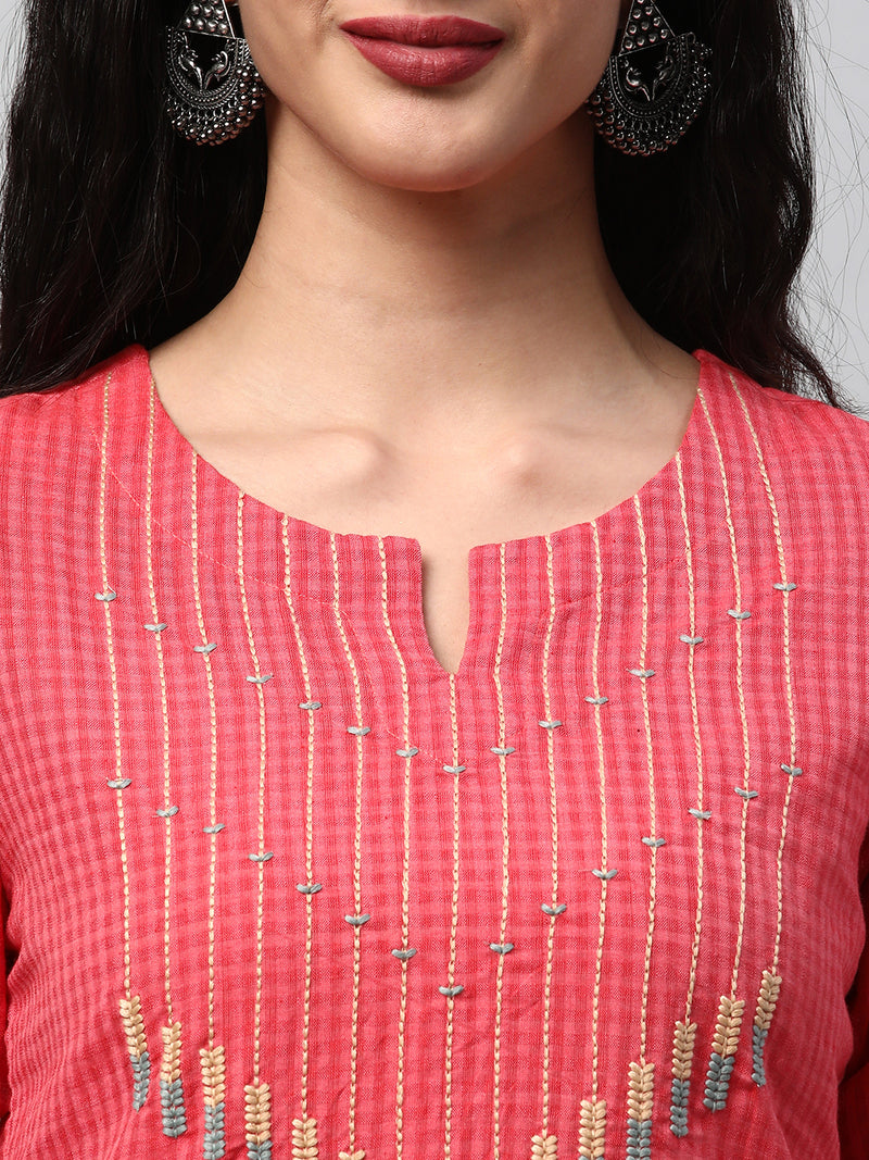 A straight kurta with machine embroidery at the center and sleeve