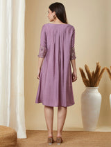 Pocketed silk blend dress with box pleating and thread embroidery.