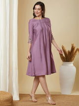 Pocketed silk blend dress with box pleating and thread embroidery.