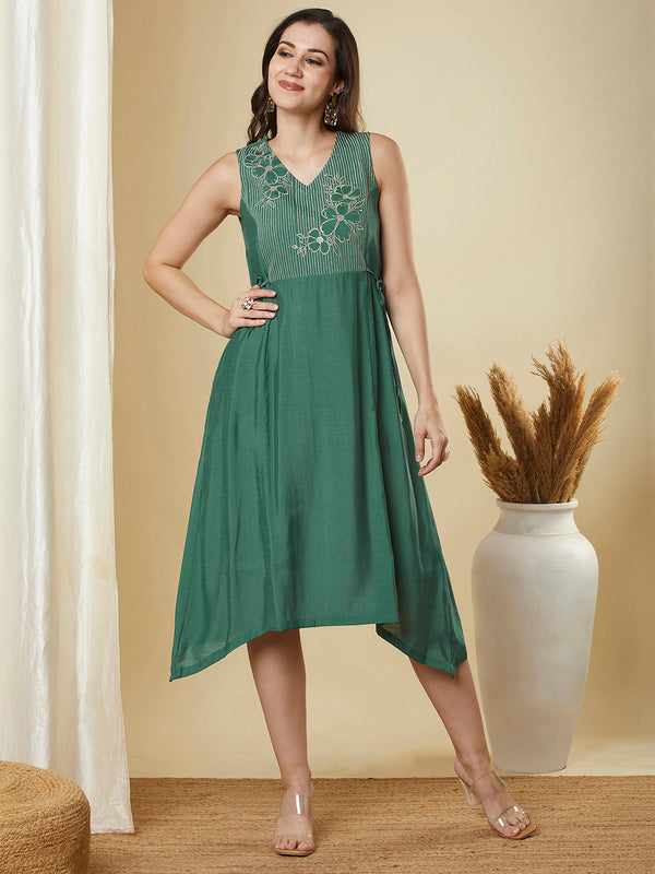 A-line high low sleeveless dress with embroidered yoke and tie-up waist.