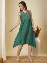 A-line high low sleeveless dress with embroidered yoke and tie-up waist.