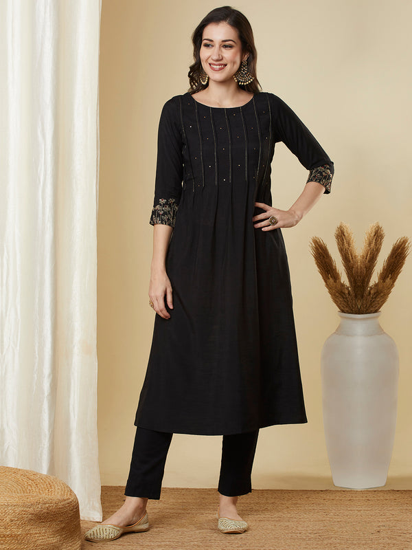 Pocketed A line kurta with zari pin tucks, sequin work and embellished sleeve.