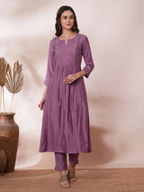 Inaara -Pocketed A line kurta adorned with zari embroidery and paired with lined silk blend pants.