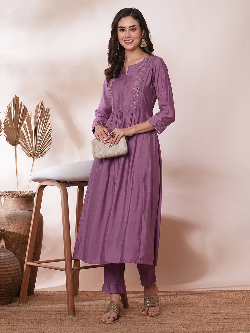 Inaara -Pocketed A line kurta adorned with zari embroidery and paired with lined silk blend pants.