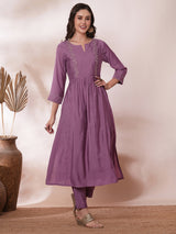 Inaara -Pocketed A line kurta adorned with zari embroidery and paired with lined silk blend pants.