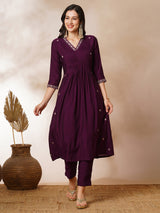 INAARA - A-line Pocketed silk blend kurta with zari embroidery and pleat detailing paired with lined pants.