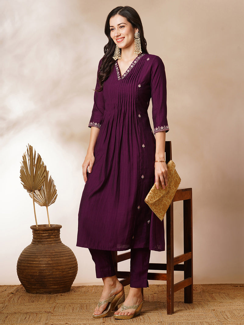 INAARA - A-line Pocketed silk blend kurta with zari embroidery and pleat detailing paired with lined pants.