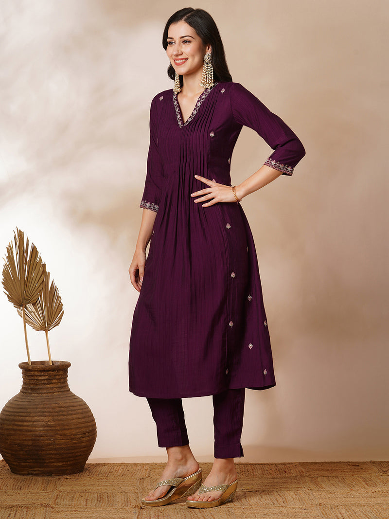 INAARA - A-line Pocketed silk blend kurta with zari embroidery and pleat detailing paired with lined pants.