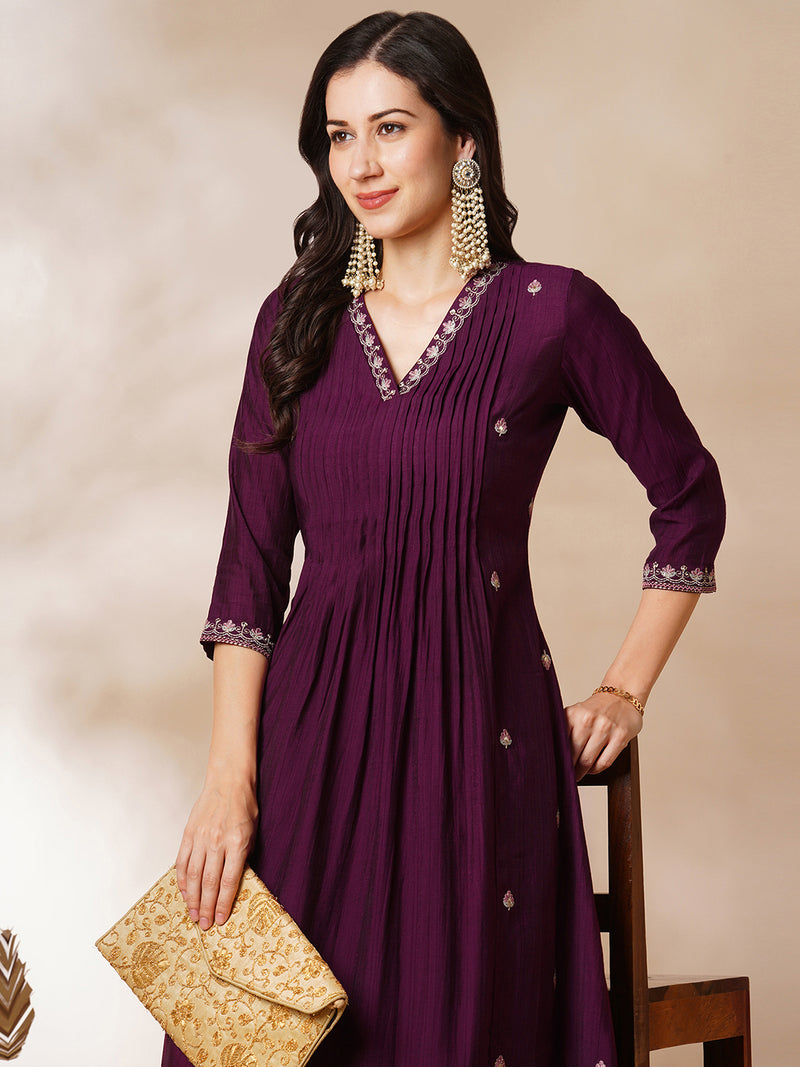 INAARA - A-line Pocketed silk blend kurta with zari embroidery and pleat detailing paired with lined pants.