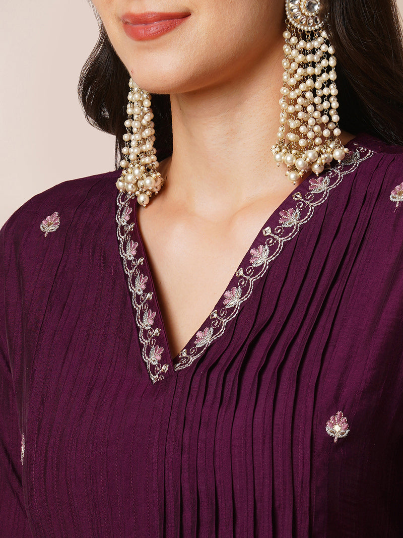 INAARA - A-line Pocketed silk blend kurta with zari embroidery and pleat detailing paired with lined pants.