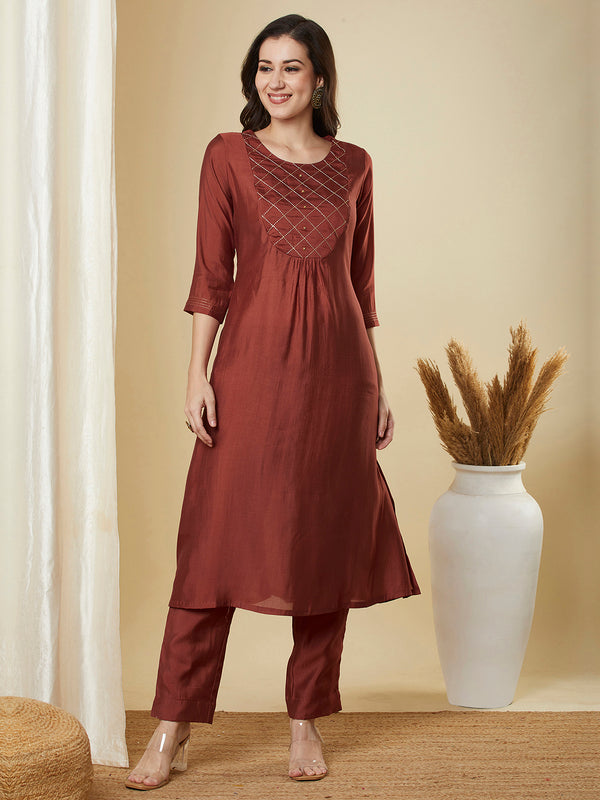 A-Line roman silk kurta set with zari embroidery with buttons on front yoke.