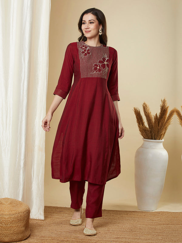 A-line shoulder princess kurta set with embroidered yoke and stitch line sleeves.