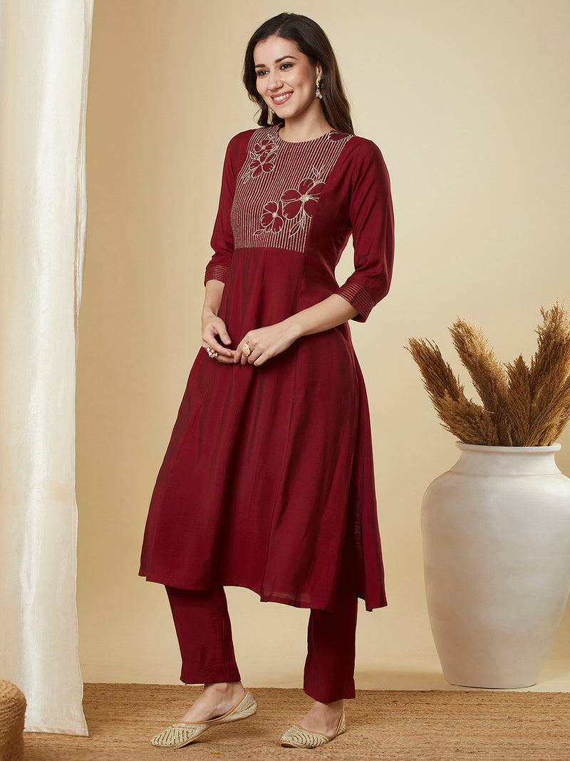 A-line shoulder princess kurta set with embroidered yoke and stitch line sleeves.