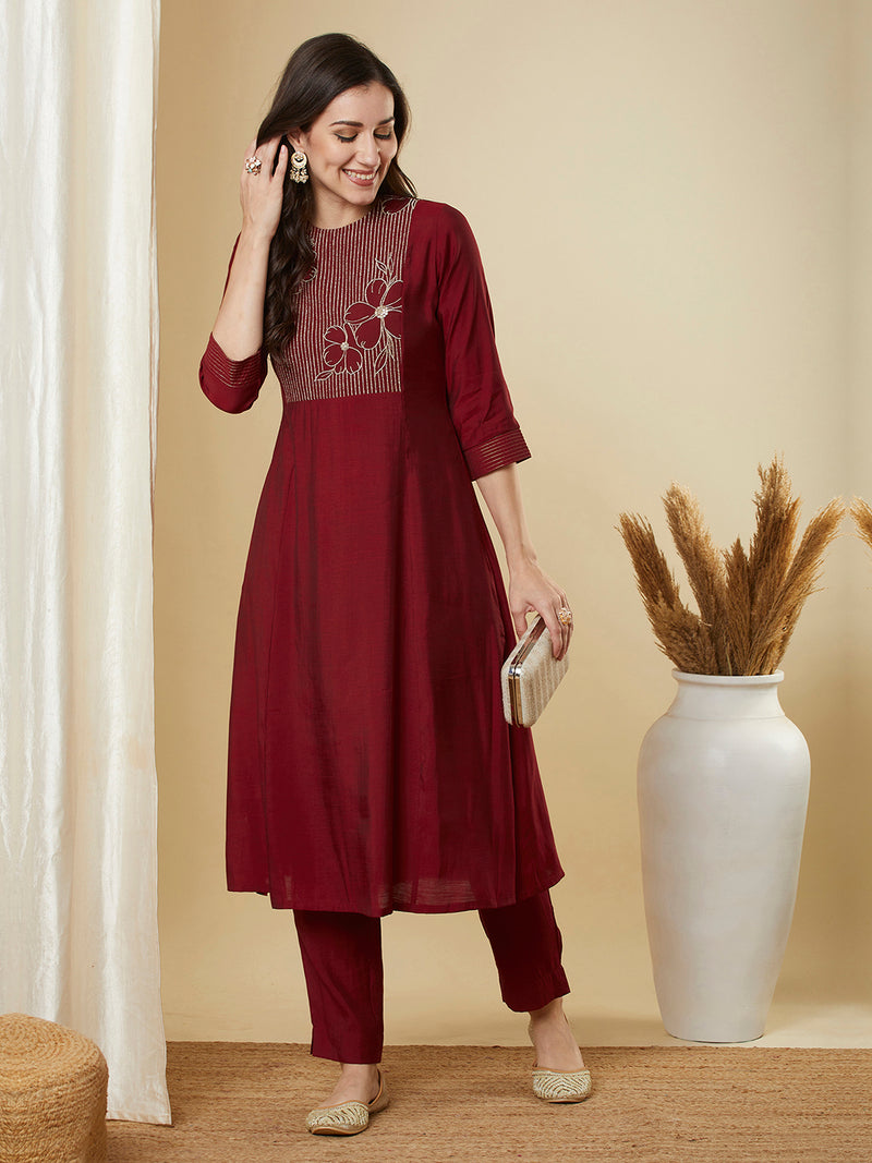 A-line shoulder princess kurta set with embroidered yoke and stitch line sleeves.