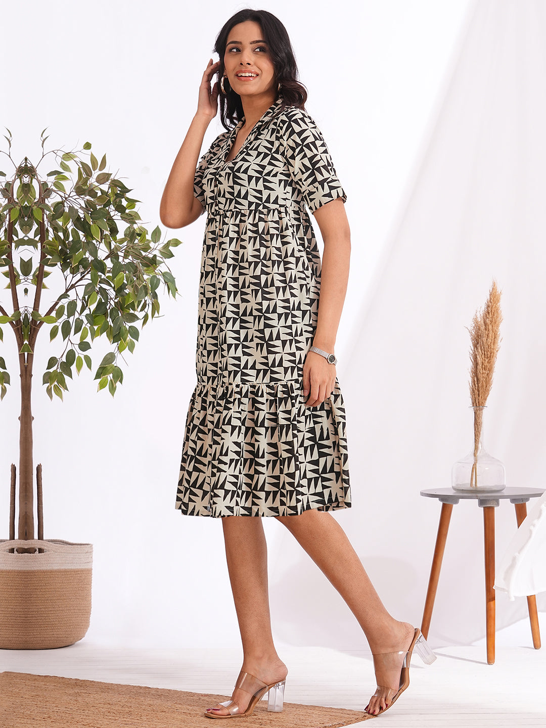 Pocketed cotton print tiered dress with a notched collar and an elbow length sleeve