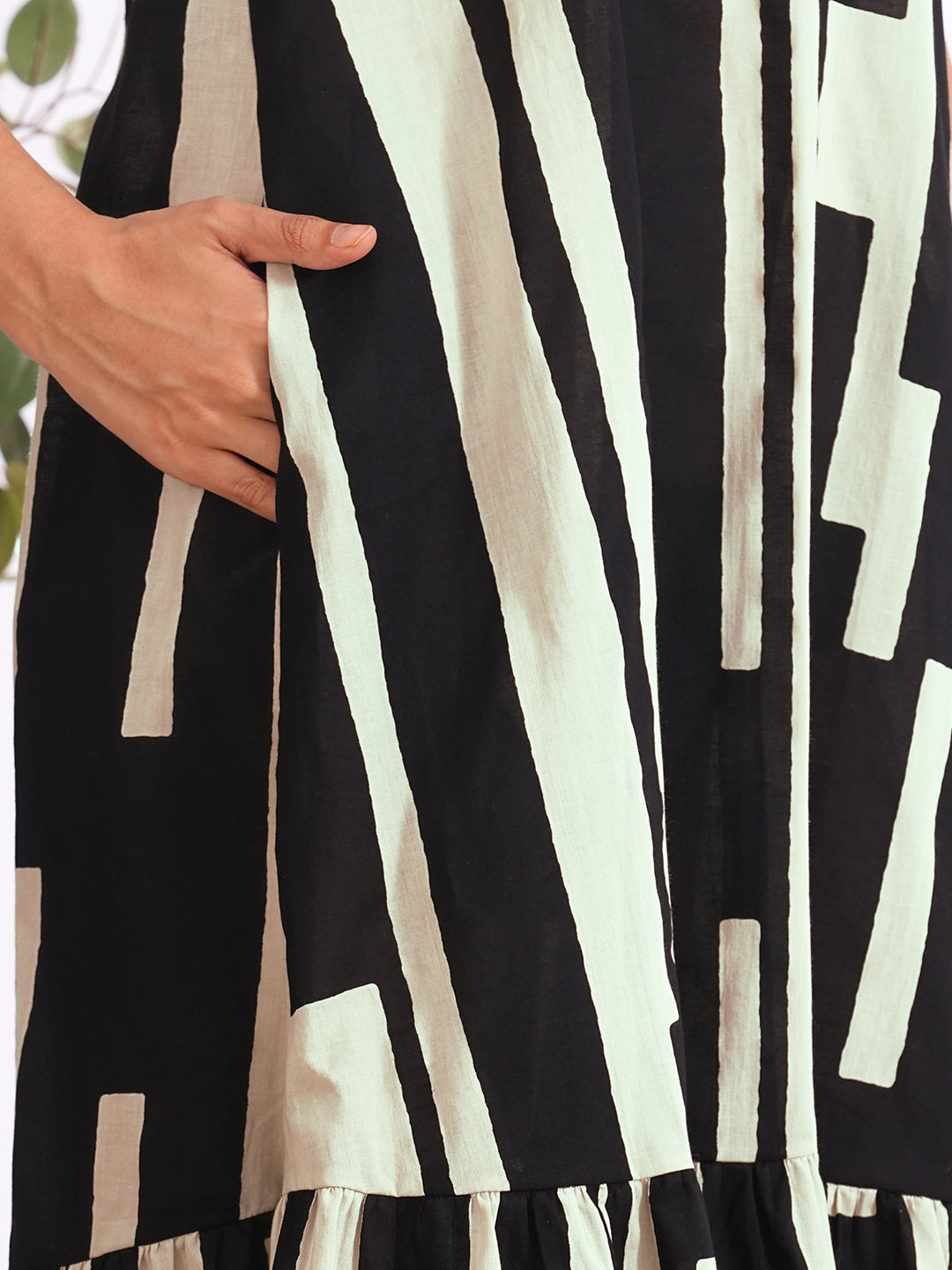 A-Line sleeveless cotton print dress with a tiered hemline and an attached in seam pocket