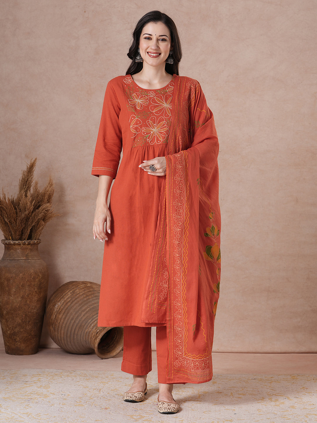 Rust Orange A-Line Kurta Set with Intricate Embroidered Yoke, Printed Dupatta and Matching Solid Pants.
