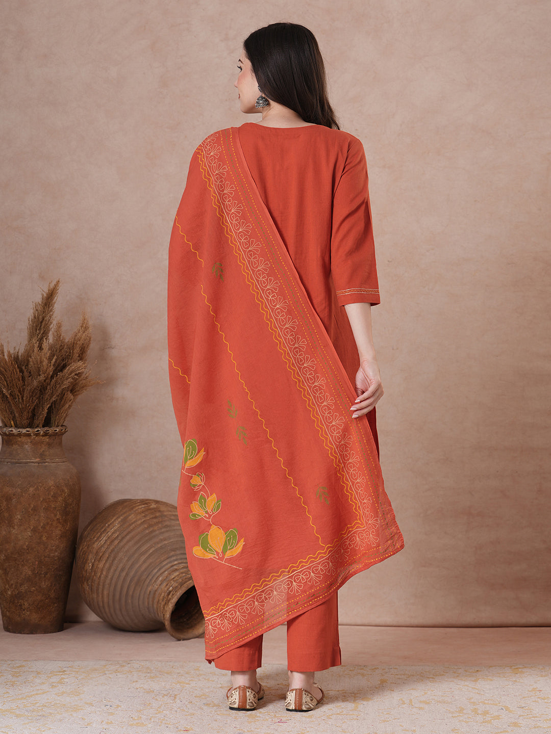 Rust Orange A-Line Kurta Set with Intricate Embroidered Yoke, Printed Dupatta and Matching Solid Pants.