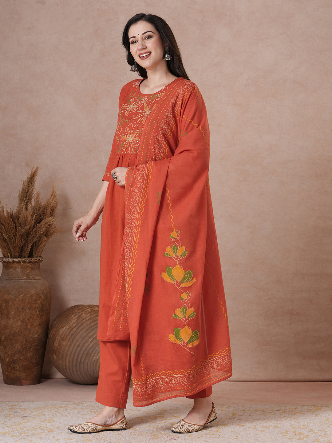 Rust Orange A-Line Kurta Set with Intricate Embroidered Yoke, Printed Dupatta and Matching Solid Pants.