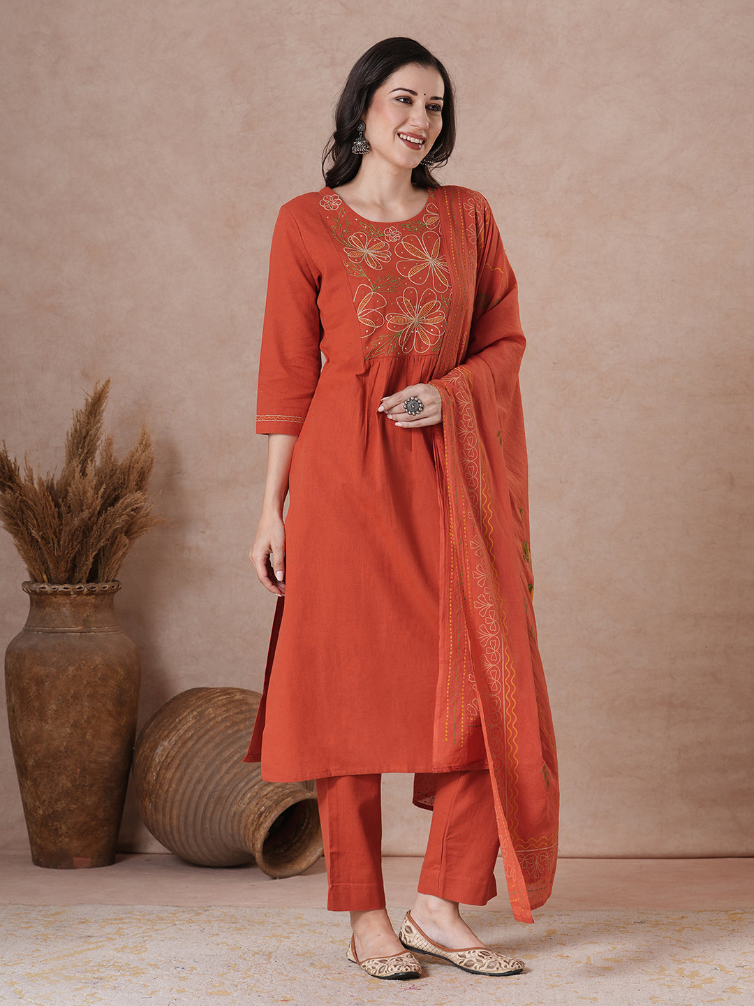Rust Orange A-Line Kurta Set with Intricate Embroidered Yoke, Printed Dupatta and Matching Solid Pants.