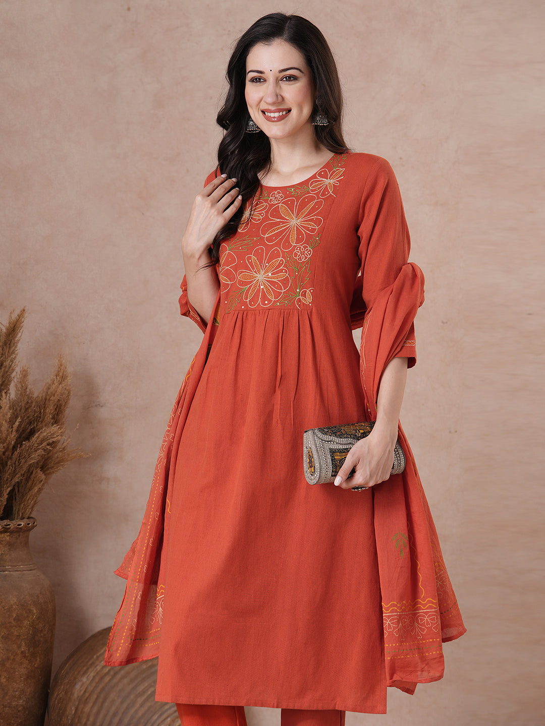 Rust Orange A-Line Kurta Set with Intricate Embroidered Yoke, Printed Dupatta and Matching Solid Pants.