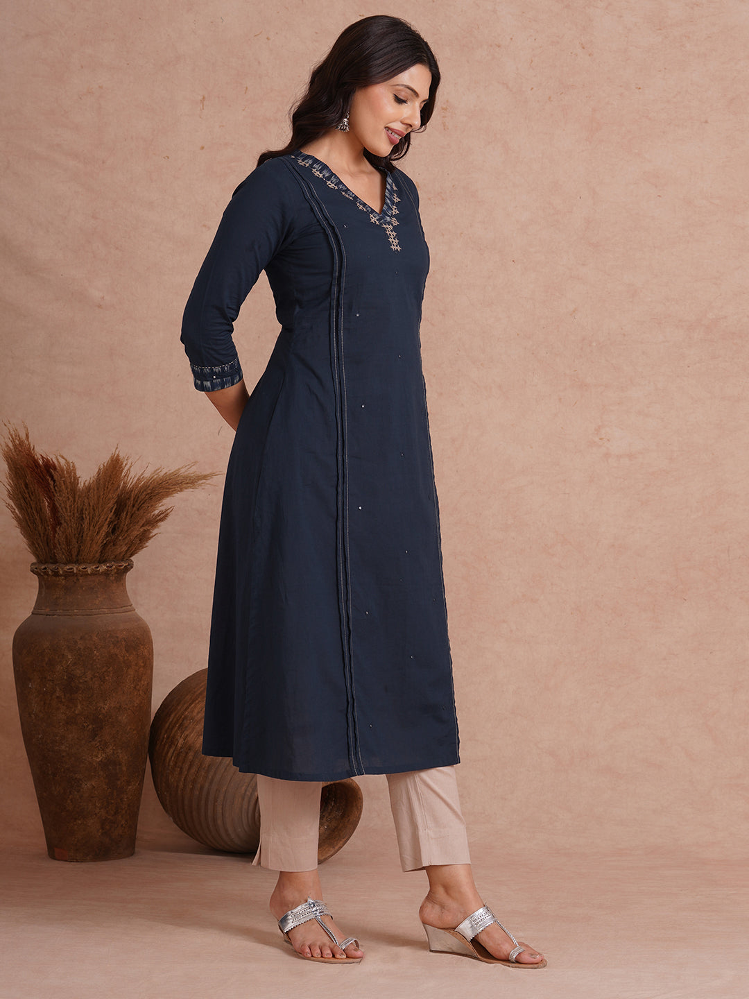 Pocketed A-Line cotton kurta with traditional 'chatakla' embroidery and mirror work.