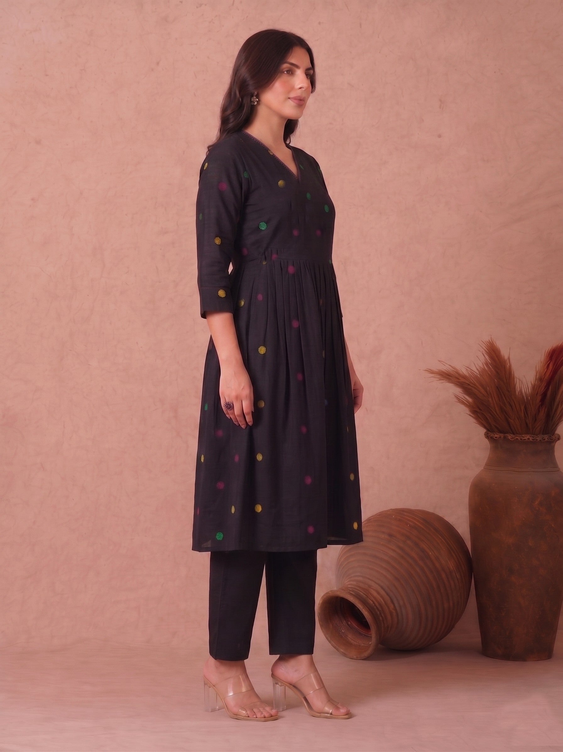 Pocketed and A-line Fit and Flare Angrakha style Dobby kurta with handwork, tassels and gathering.