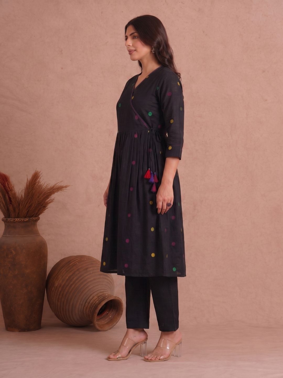 Pocketed and A-line Fit and Flare Angrakha style Dobby kurta with handwork, tassels and gathering.