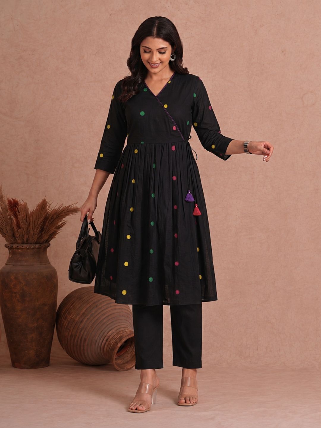 Pocketed and A-line Fit and Flare Angrakha style Dobby kurta with handwork, tassels and gathering.