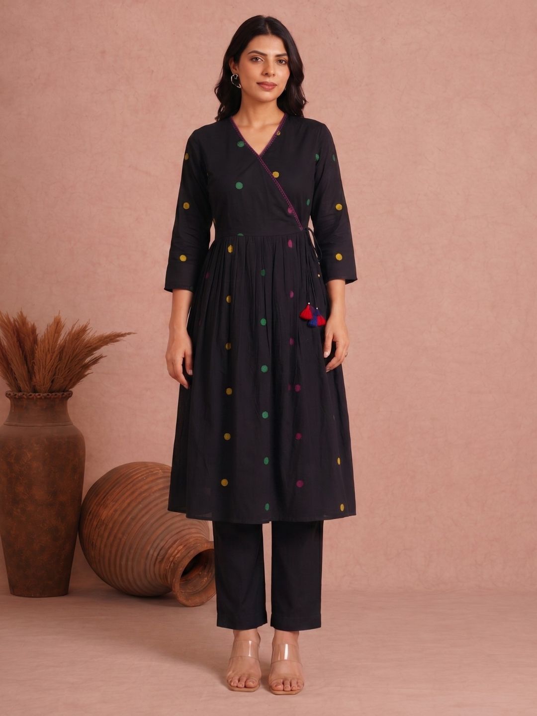 Pocketed and A-line Fit and Flare Angrakha style Dobby kurta with handwork, tassels and gathering.