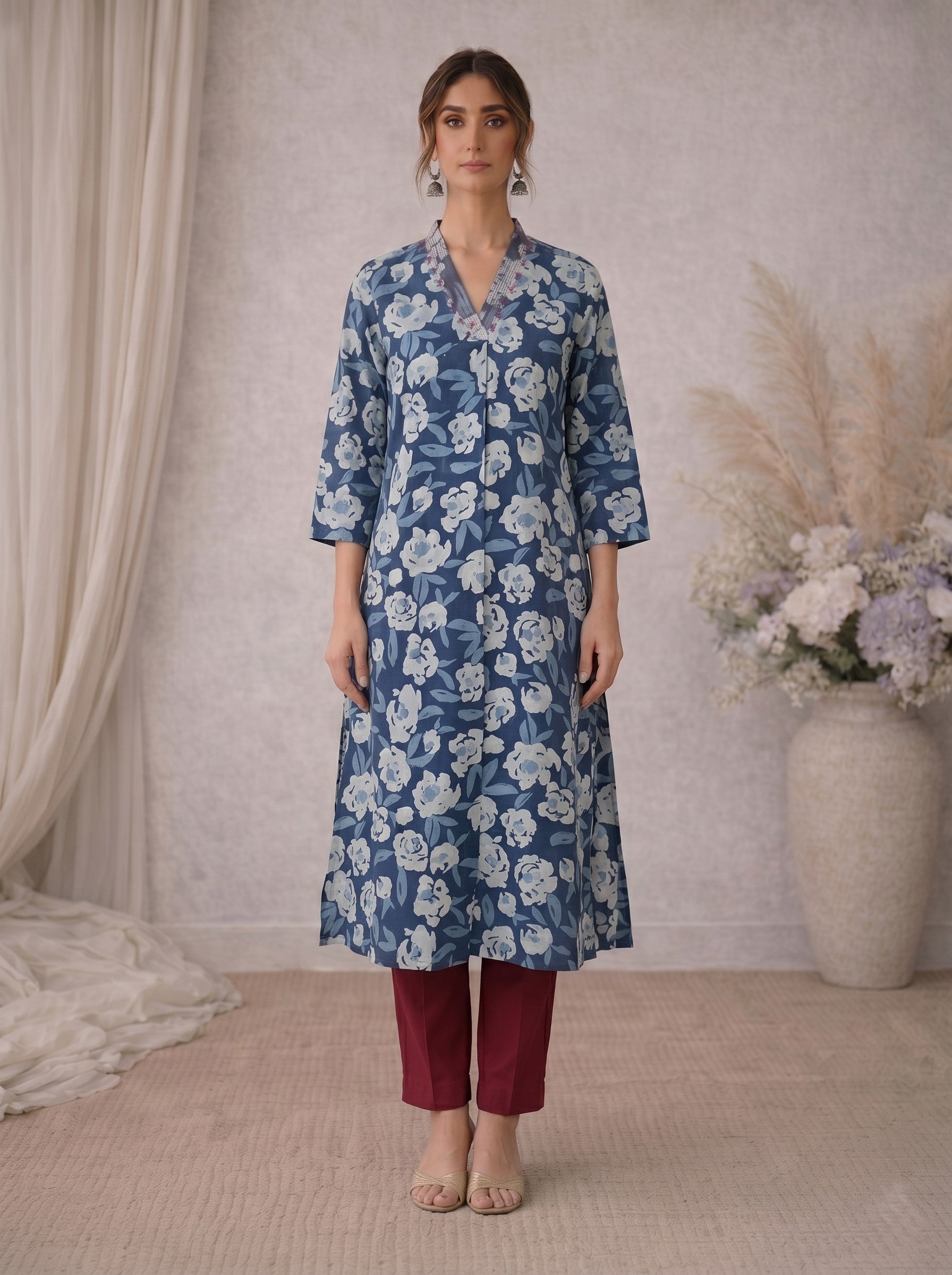 Pocketed A-line kurta in cotton dhabu print with hand embroidery detailing.