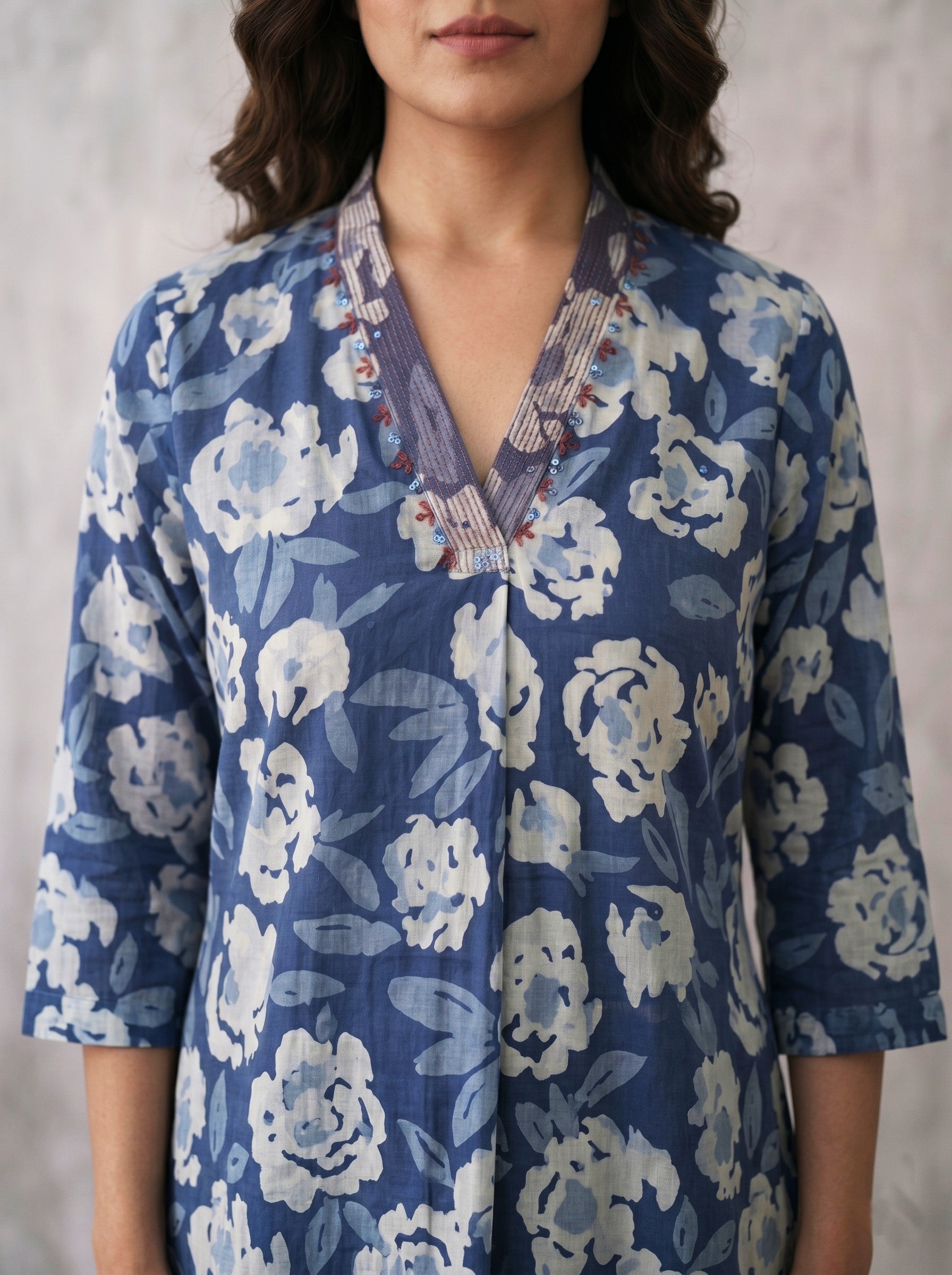 Pocketed A-line kurta in cotton dhabu print with hand embroidery detailing.