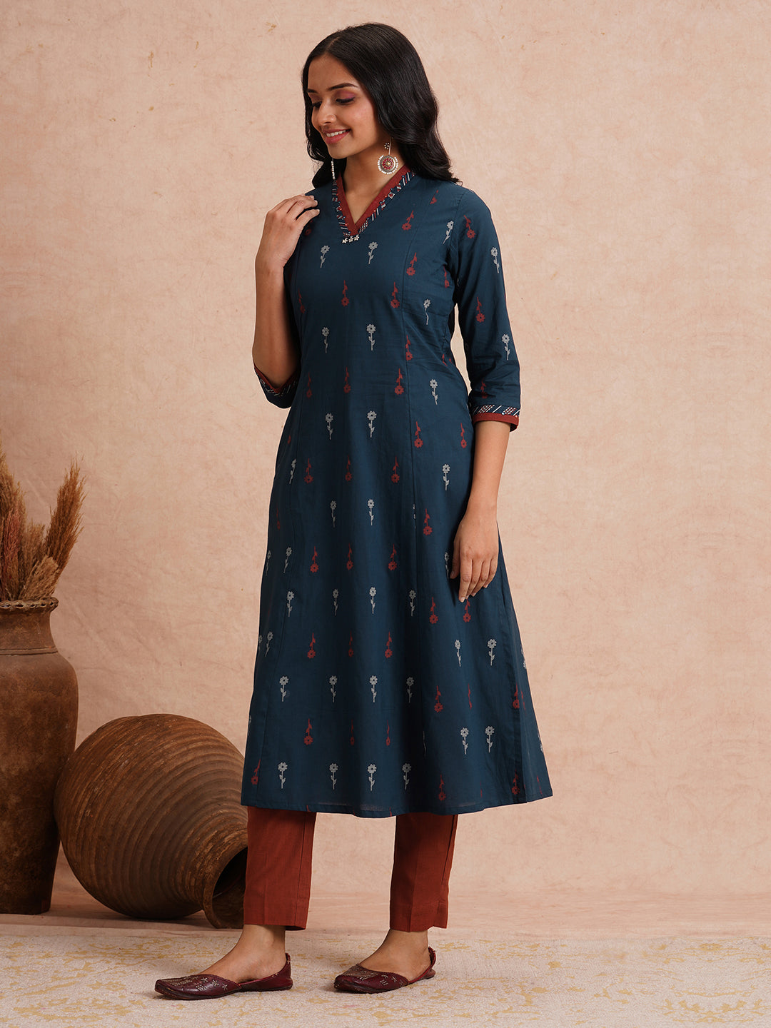 Printed A-line kurta with contrast fabric detailing with mirror work.
