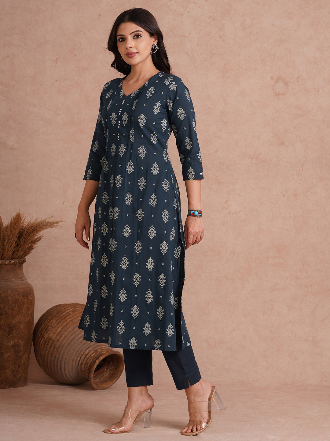 A-line kurta with tucks and box pleat in the front highlighted with handwork mirrors.