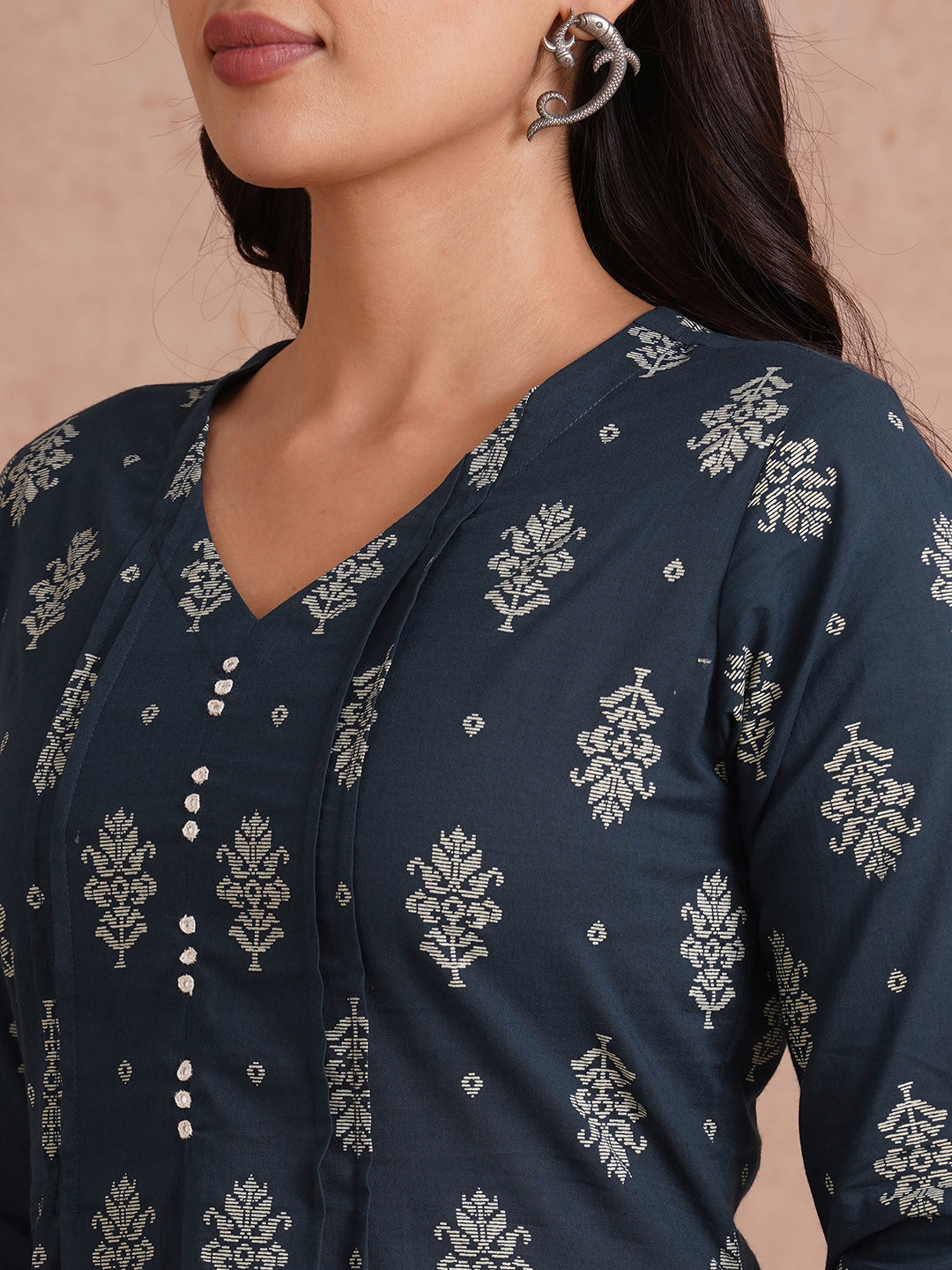 A-line kurta with tucks and box pleat in the front highlighted with handwork mirrors.