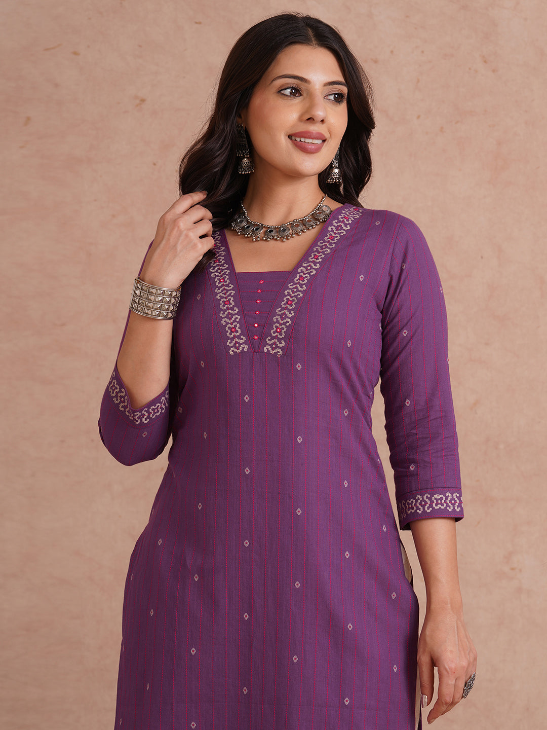 Straight fit dobby stripe kurta with block printed neckline and placement block on hem.