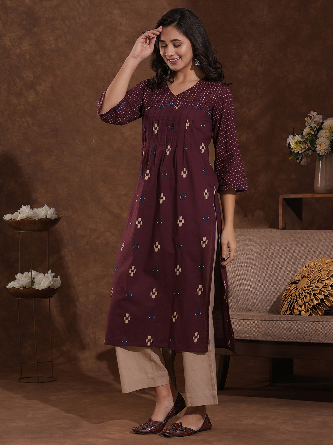 Printed straight fit kurta with shoulder yoke and tucks highlighted with handwork on yoke and sleeves.