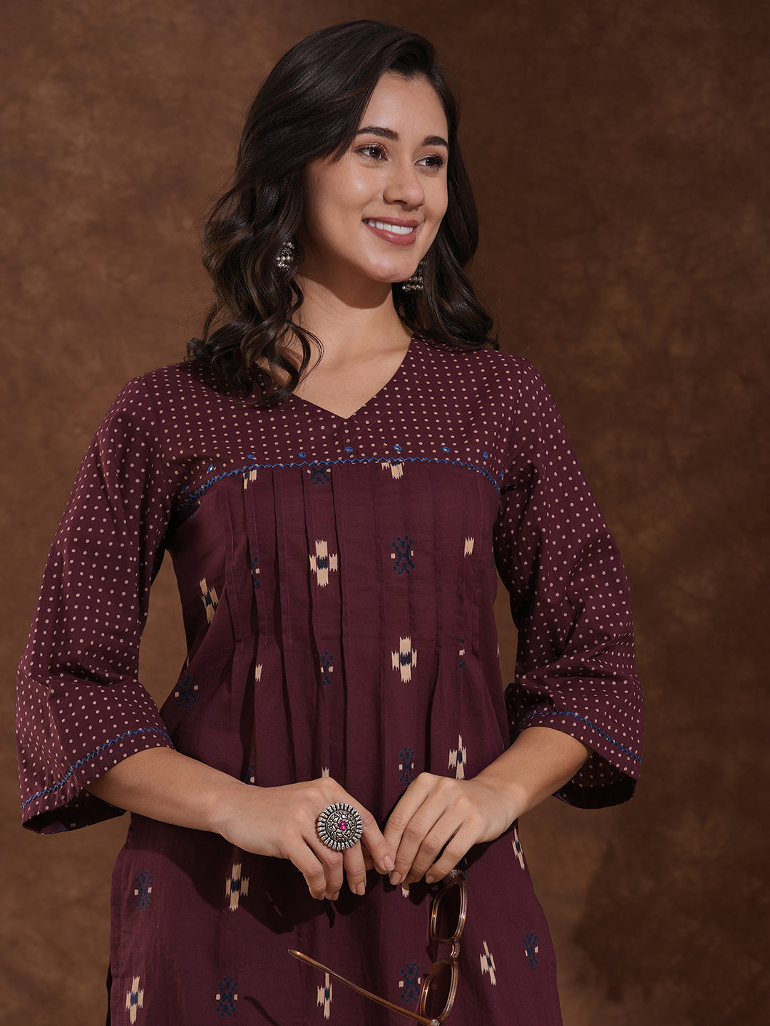 Printed straight fit kurta with shoulder yoke and tucks highlighted with handwork on yoke and sleeves.