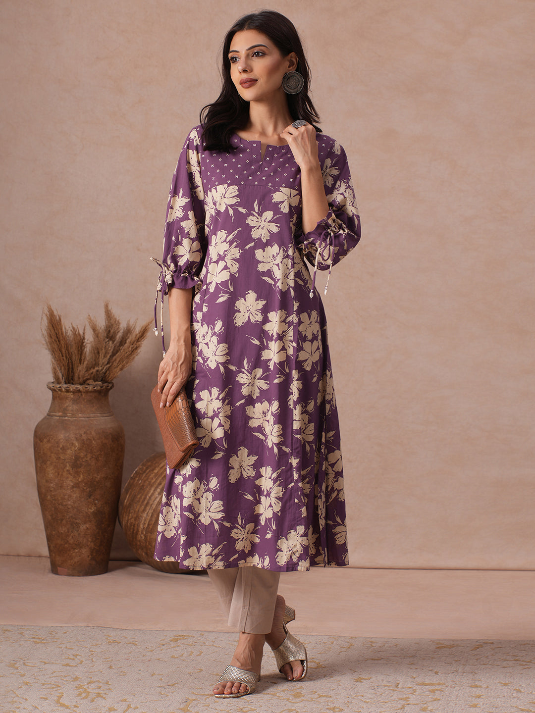 A-line Printed Cotton Kurta with Hand Sequined Yoke and Stylish Tie-Up Sleeves.
