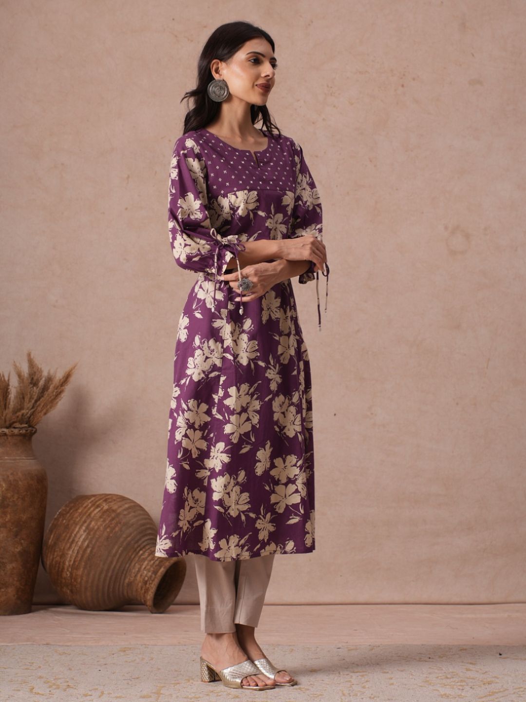 A-line Printed Cotton Kurta with Hand Sequined Yoke and Stylish Tie-Up Sleeves.