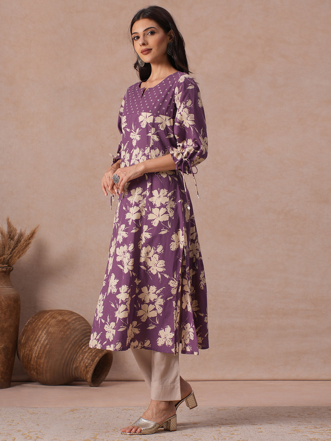 A-line Printed Cotton Kurta with Hand Sequined Yoke and Stylish Tie-Up Sleeves.
