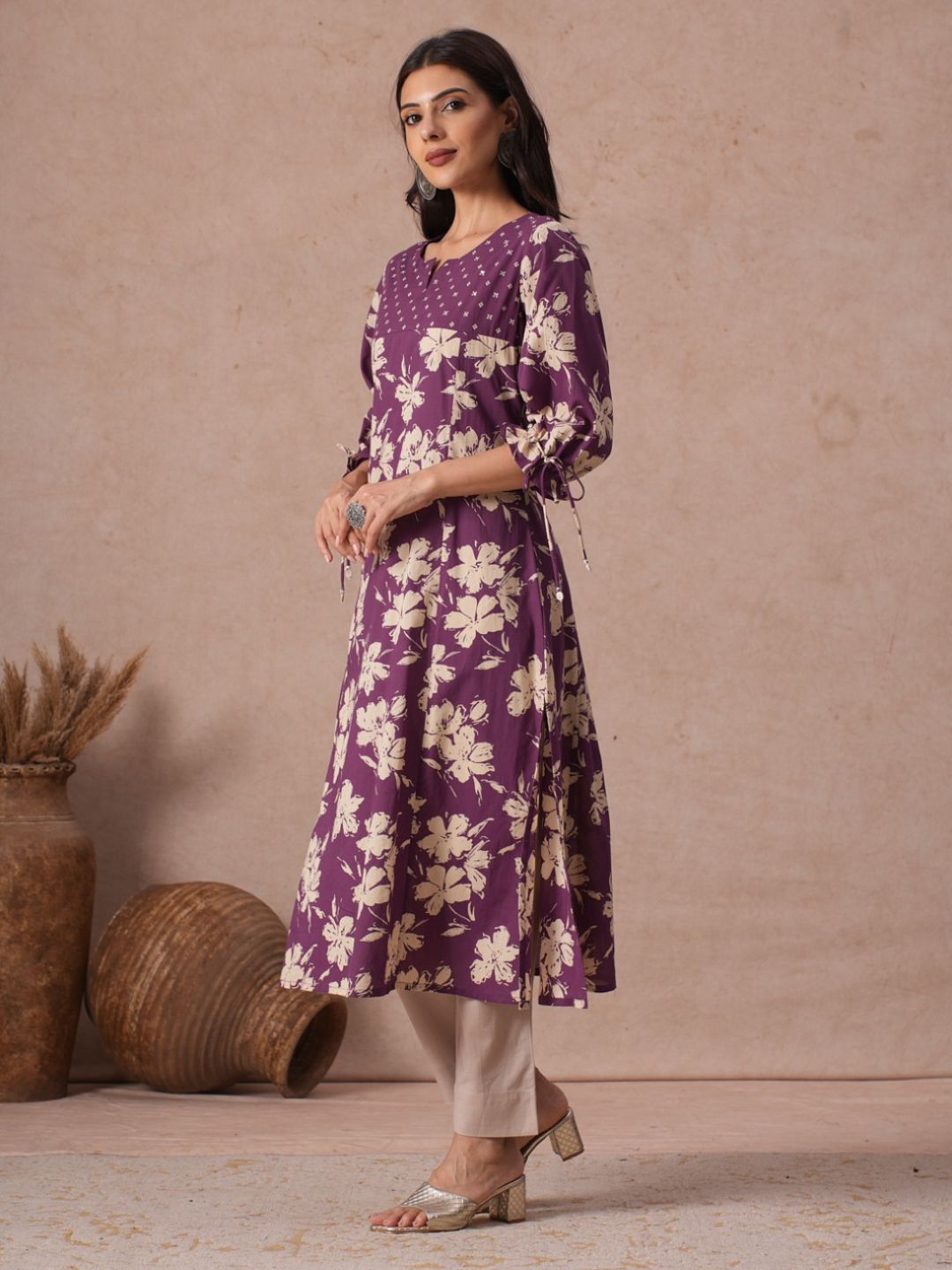 A-line Printed Cotton Kurta with Hand Sequined Yoke and Stylish Tie-Up Sleeves.