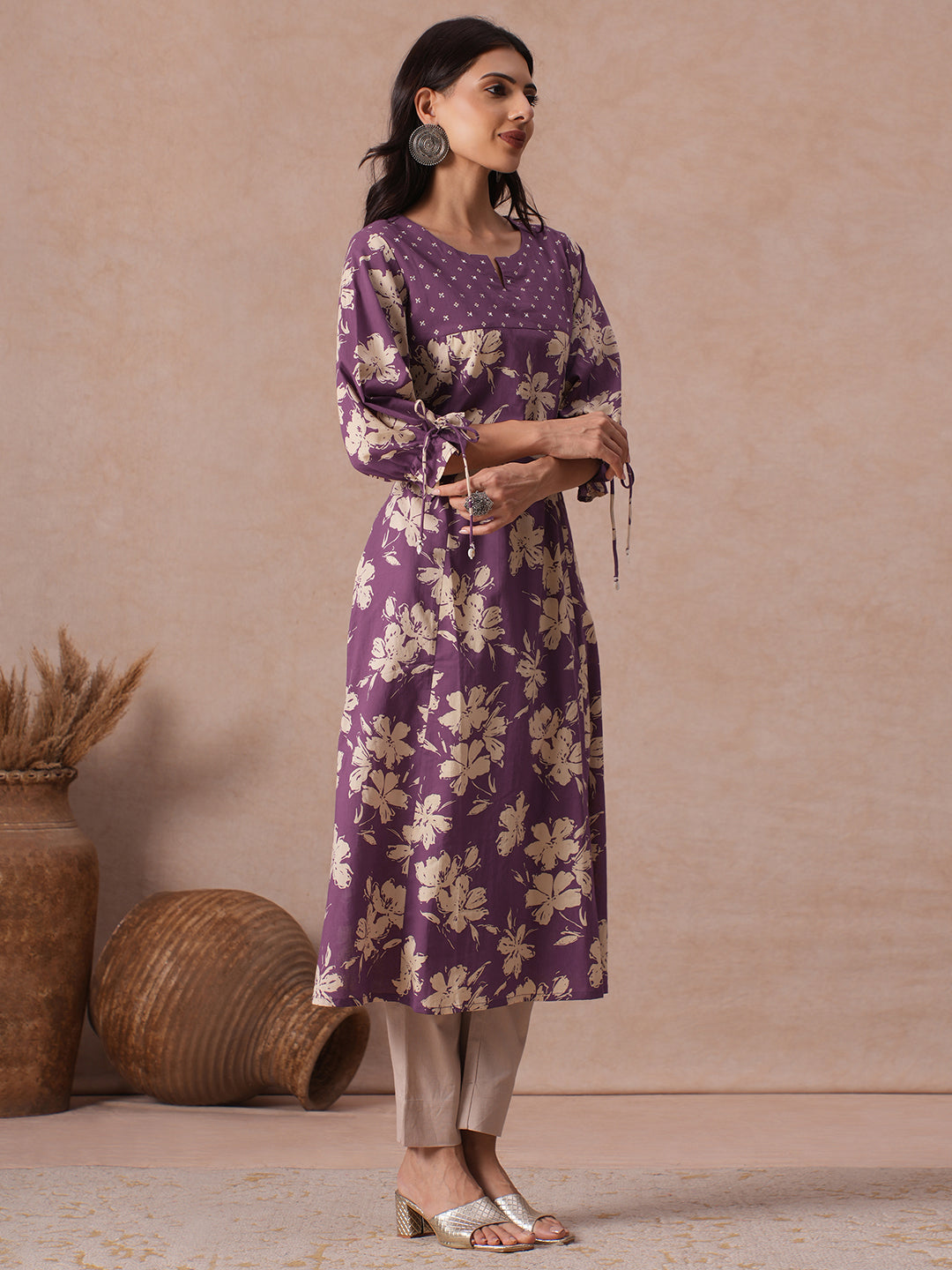 A-line Printed Cotton Kurta with Hand Sequined Yoke and Stylish Tie-Up Sleeves.