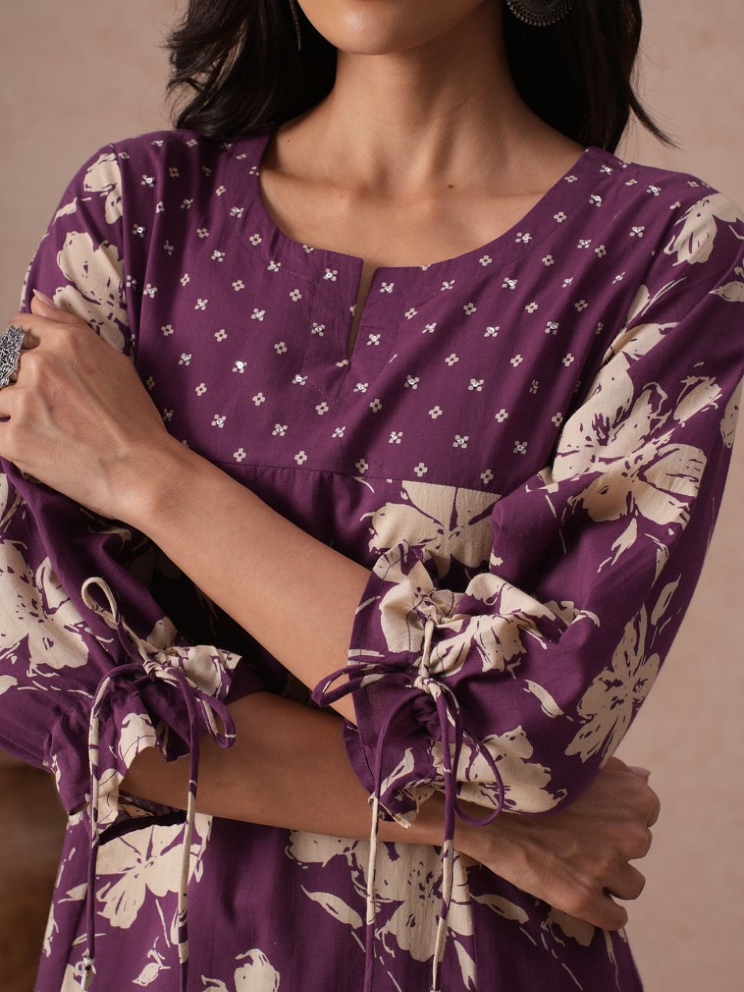 A-line Printed Cotton Kurta with Hand Sequined Yoke and Stylish Tie-Up Sleeves.
