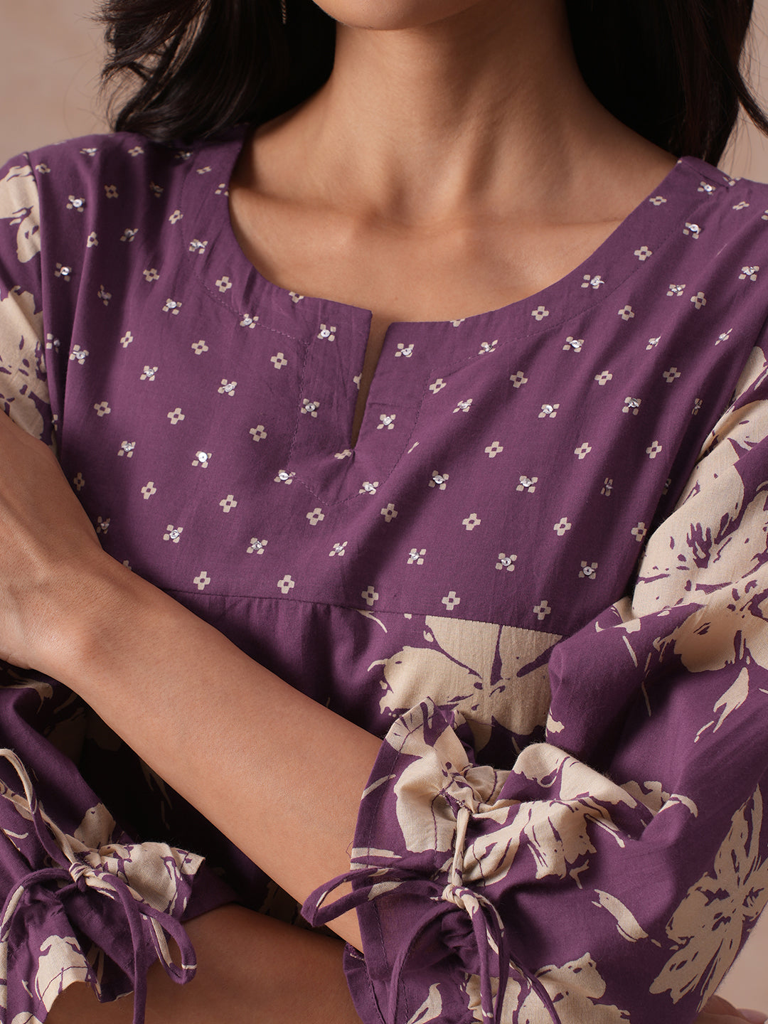 A-line Printed Cotton Kurta with Hand Sequined Yoke and Stylish Tie-Up Sleeves.
