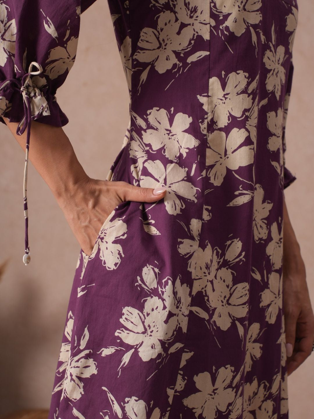 A-line Printed Cotton Kurta with Hand Sequined Yoke and Stylish Tie-Up Sleeves.