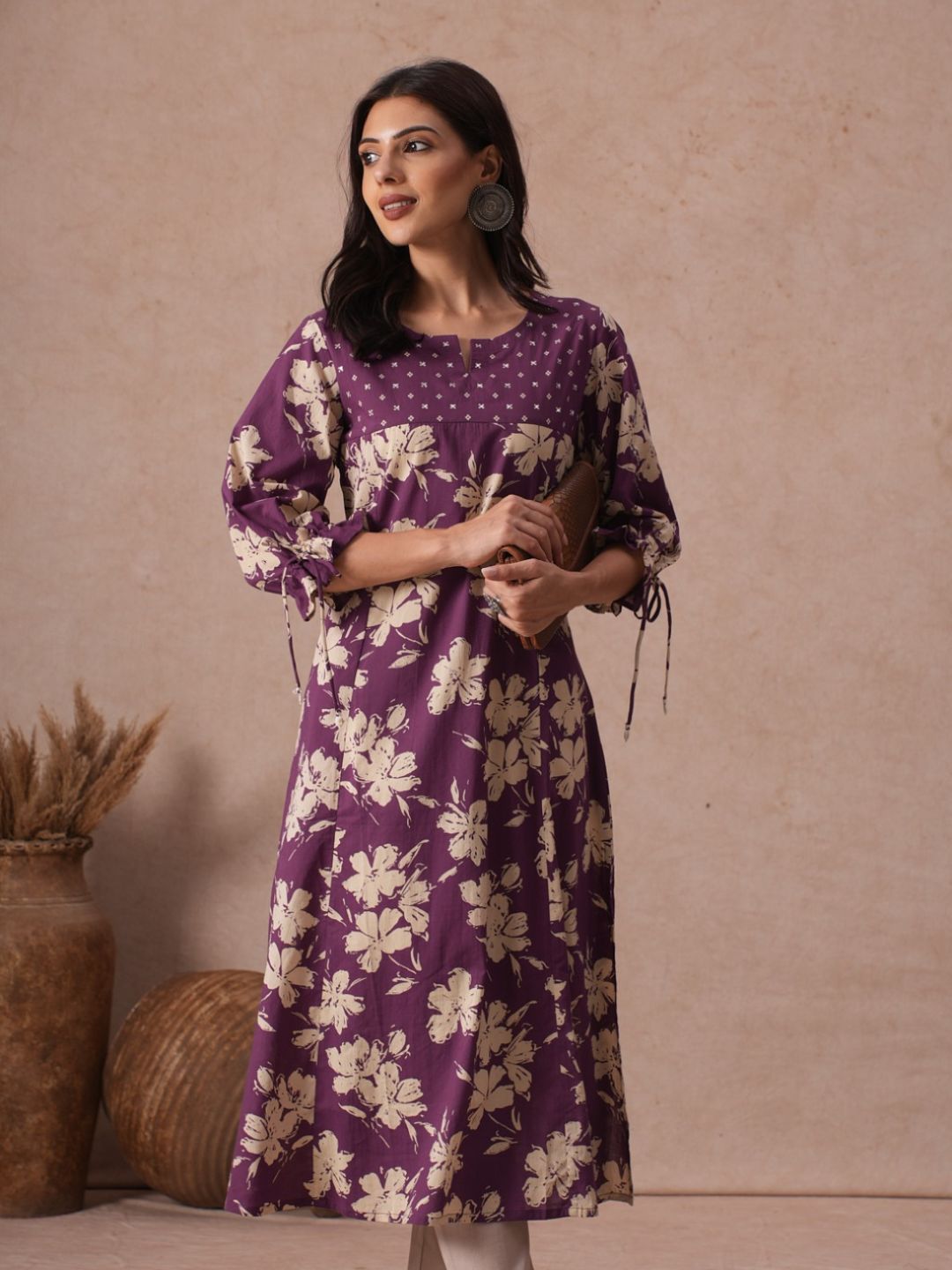 A-line Printed Cotton Kurta with Hand Sequined Yoke and Stylish Tie-Up Sleeves.