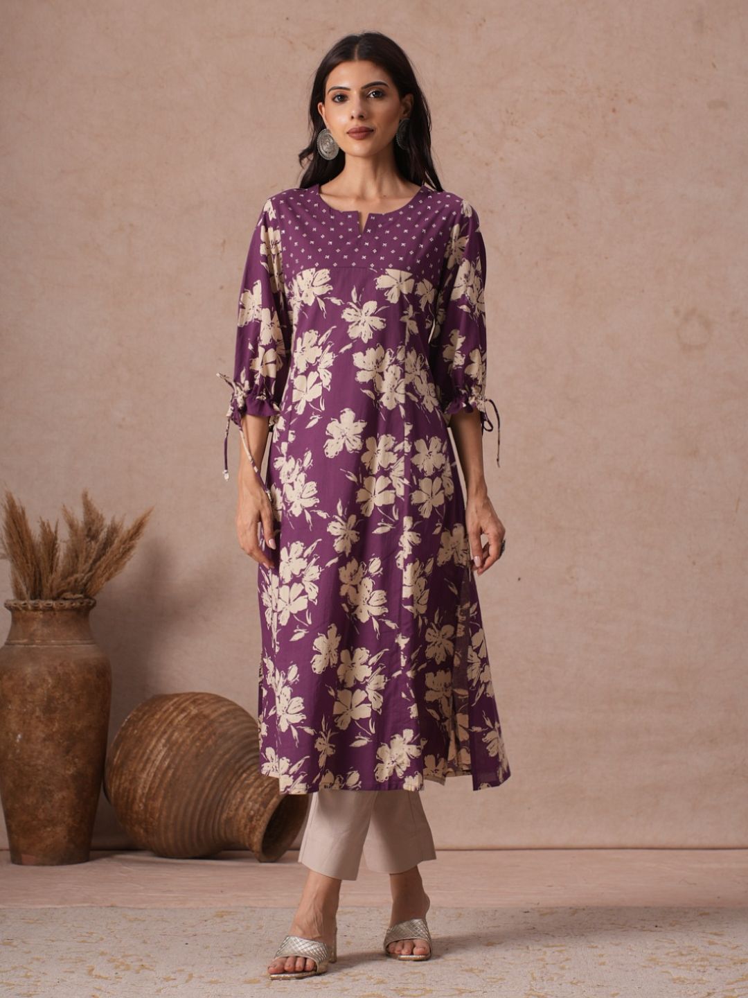 A-line Printed Cotton Kurta with Hand Sequined Yoke and Stylish Tie-Up Sleeves.